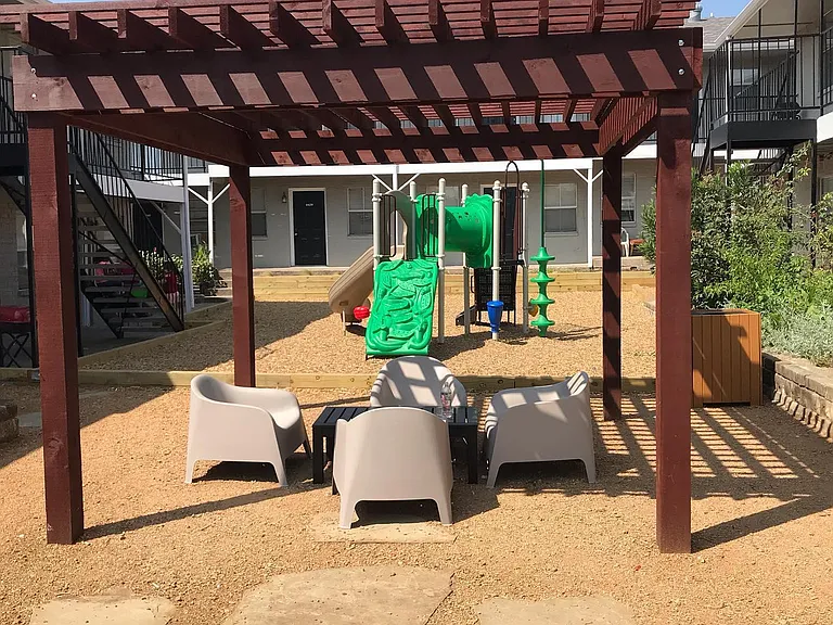 Outdoor seating and playground at Polk Villas